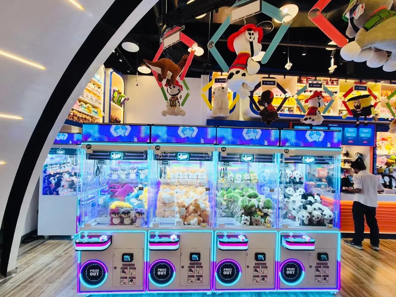 Rows of claw machines filled with colourful plush toys at Claw Culture